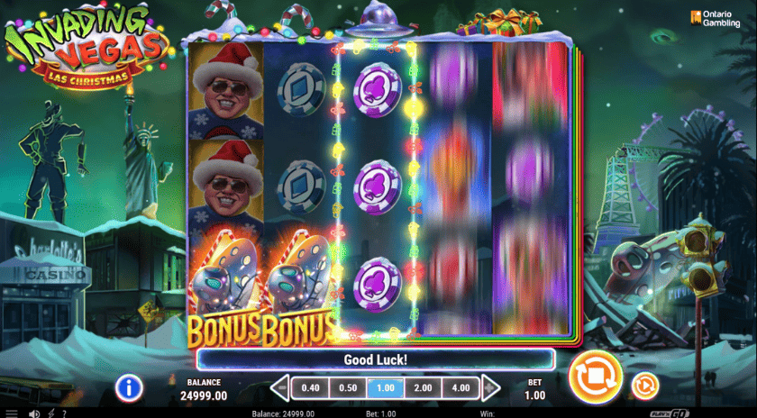 Screenshot of 'Invading Vegas: Las Christmas' slot game interface showing reels, bonus symbols, and a snowy Las Vegas backdrop.